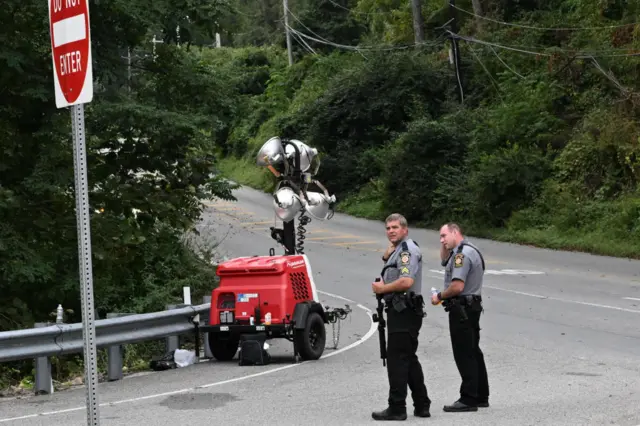 Police with rifles monitor a wooded perimeter on day 10 of a manhunt for convicted murderer Danelo Cavalcante on September 9, 2023 in Kennett Square, Pennsylvania. Cavalcante escaped from Chester County Prison on August 31