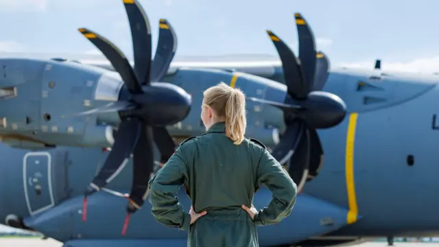 A Female Military Captain watches as two German armed forces transport planes loaded with technical relief supplies are pictured before flying to Libya