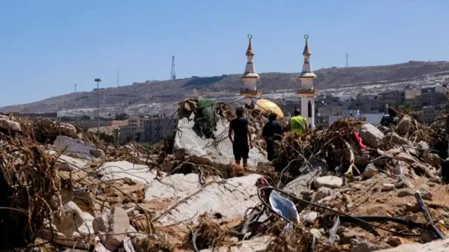 Survivors surrounded by debris, Derna