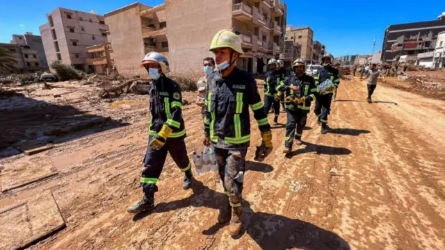 Members of the rescue team from the Egyptian army walk on the street in Derna