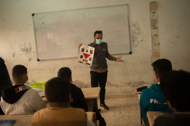 Mohammed Gajoum a member of the awareness team and Danish Demining Group, gives a lecture to middle school students on the dangers of the landmines and remnants of war at Dar El-Baida elementary and middle school in southern Tripoli, Ain-Zara on March 22, 2022 Tripoli, Libya.