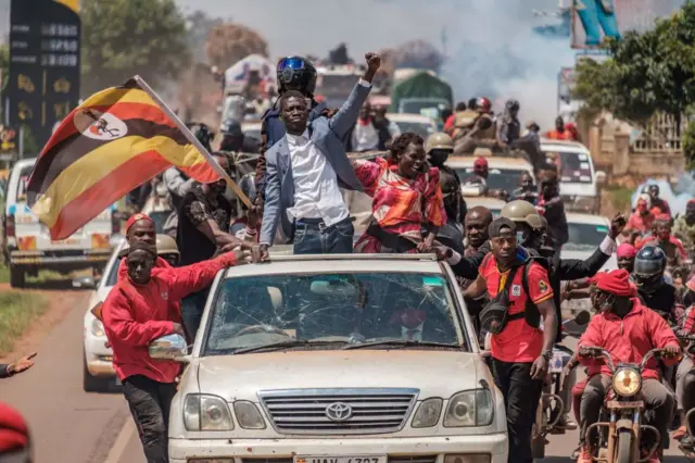 Ugandan musician-turned-politician Robert Kyagulanyi, also known as Bobi Wine (C), greets supporters as he sets off on his campaign trail towards eastern Uganda, near Kayunga, on December 1, 2020.