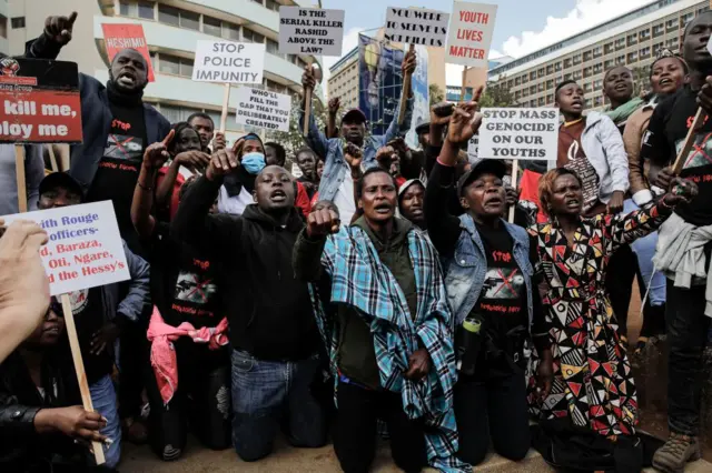 Families of victims of police extra judicial killings along with civil society members gather on December 08, 2022 outside the Milimani Law courts to show support for the arraignment of a Kenyan police officer, Ahmed Rashid, infamous for an execution-style street shooting in 2017 of suspected criminals in Nairobi.