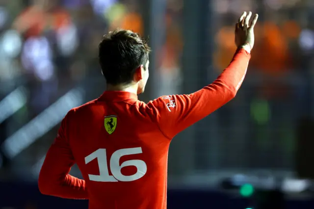 Charles Leclerc waves to the crowd after securing pole in 2022