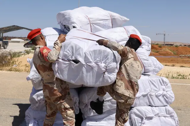 Libyan military officers handle the aid supplies the United Arab Emirates sent for Derna flood survivors in Benghazi - 15 September 2023