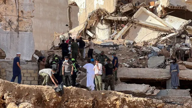 Rescuers work at the port city of Derna, eastern Libya, 14 September 2023