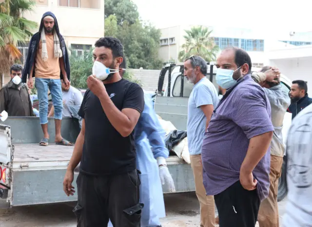 People wear mask after the floods caused by the Storm Daniel ravaged disaster zones in Derna, Libya on September 12, 2023