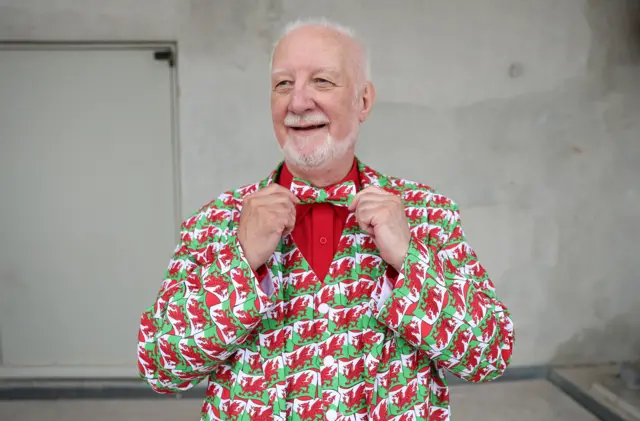 man dressed in Welsh flag suit