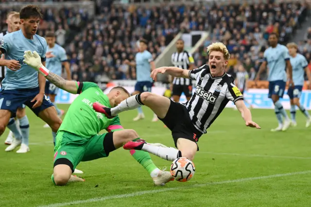 Anthony Gordon of Newcastle United is fouled by Mark Flekken