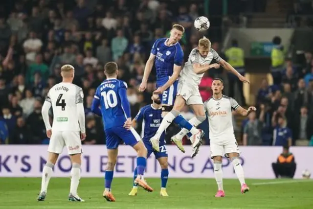 Cardiff City players battle with Swansea City players