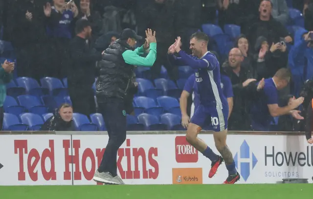 Cardiff City boss Erol Bulut celebrates with Aaron Ramsey