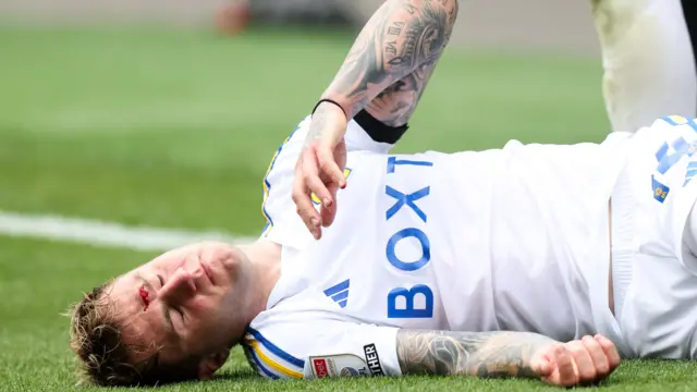 Joe Rodon lies injured against Millwall