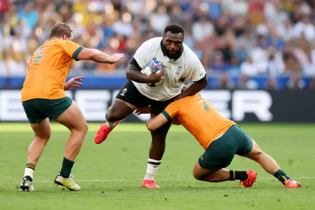 Luke Tagi of Fiji is tackled by Fraser McReight of Australia