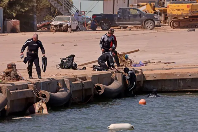 Members of the Russian rescue team dive in the sea to retrieve bodies in Libya's eastern port city of Derna on September 18, 2023, following deadly flash floods