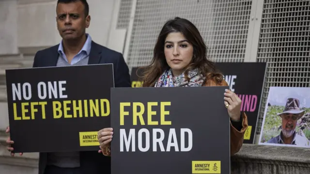 Roxanne Tahbaz (R), daughter of Morad Tahbaz, and Sacha Deshmukh, Interim Chief Executive Officer of Amnesty UK (L) hold placards outside the Foreign, Commonwealth and Development Office on 13 April 2022 in London, England.