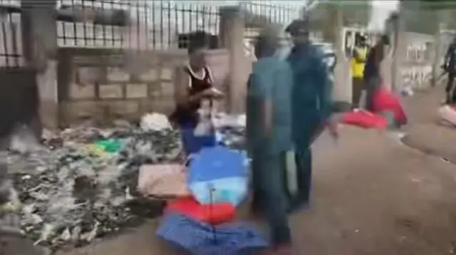 A still from footage of Emmanuel Khamis Richard, where is about to strike the female vendor.