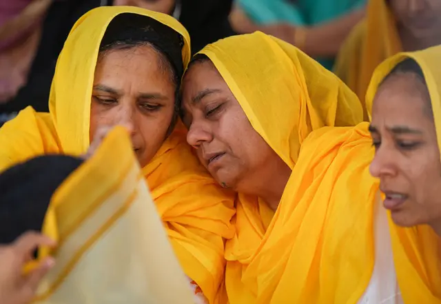 People mourn Sikh community leader and temple president Hardeep Singh Nijjar during Antim Darshan, the first part of day-long funeral services for him, in Surrey, B.C., Sunday, June 25, 2023.