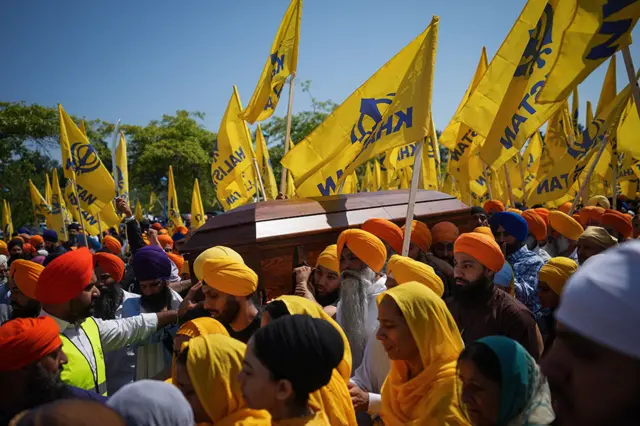 Mourners carry the casket of Sikh community leader and temple president Hardeep Singh Nijjar during Antim Darshan, the first part of a day-long funeral service for him, in Surrey, B.C., Sunday, June 25, 2023.