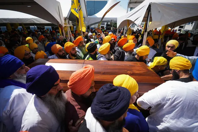 Mourners carry the casket of Sikh community leader and temple president Hardeep Singh Nijjar during Antim Darshan, the first part of day-long funeral services for him, in Surrey, B.C., Sunday, June 25, 2023.