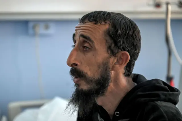 Abdelqader al-Omrani, 48, a survivor of the recent flooding in Libya's eastern city of Derna who lost six family members in the disaster, speaks during an interview at the Benghazi Medical Centre hospital in Benghazi - 18 September 2023