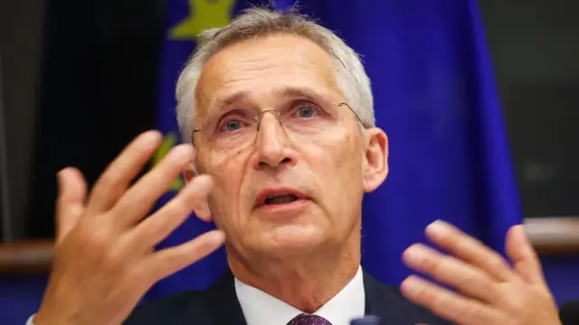 Stoltenberg gestures as he speaks at a NATO meeting