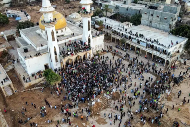 People gather for a demonstration outside the surviving Al-Sahaba mosque in Libya's eastern city of Derna on September 18, 2023, as they protest against government neglect to the two dams which broke and led to the deadly flash floods that hit the city the prior week.