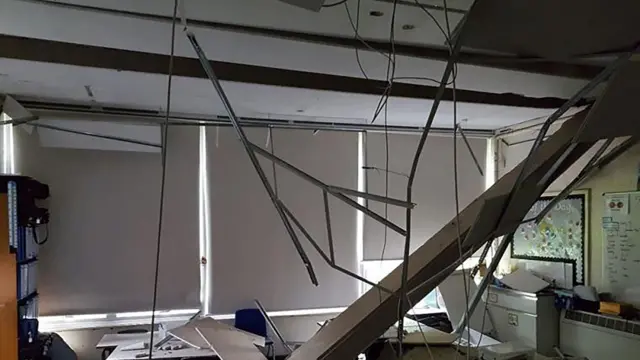 A collapsed ceiling exposing loose wires and materials at Singlewell Primary School in Gravesend, Kent