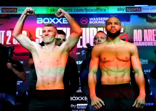 Liam Smith holds his arms up as he stands next to Chris Eubank Jr