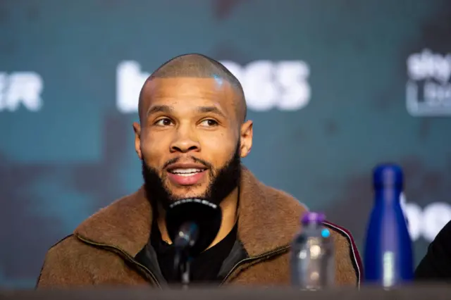 Chris Eubank Jr sits in front of a microphone