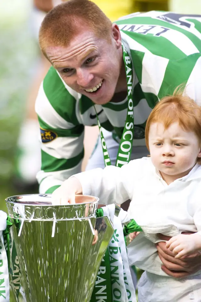 Neil Lennon celebrates the 06-07 SPL trophy with his son Gallagher...