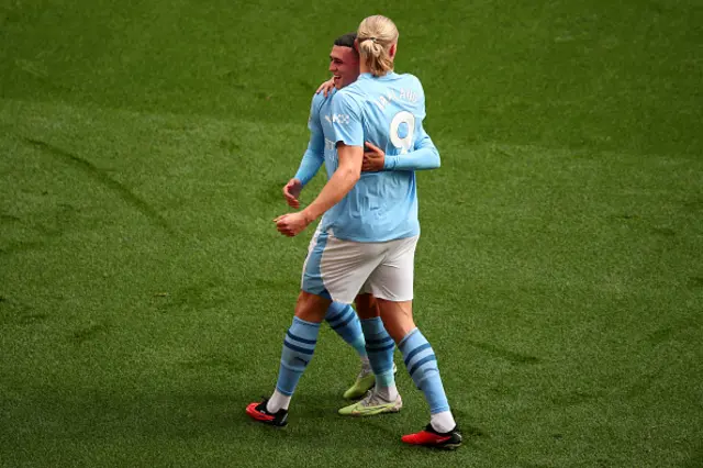 Phil Foden hugs Erling Haaland