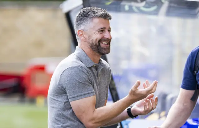 Stephen Robinson smiles pre-kick-off