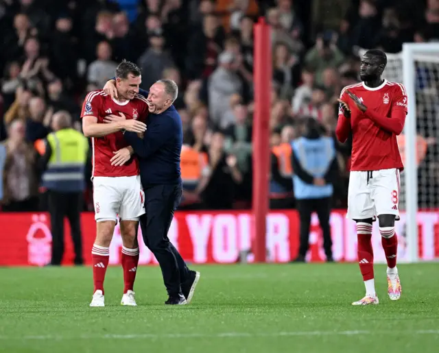 Steve Cooper congratulates Chris Wood on the pitch at full time.