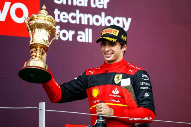 Carlos Sainz lifts the British Grand Prix trophy at Silverstone