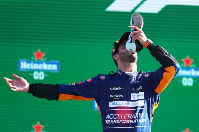 Daniel Ricciardo does a shey on the podium at Monza in 2021