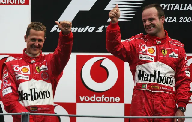 Michael Schumacher and Rubens Barrichello celebrate a Ferrari one-two on the podium in 2004