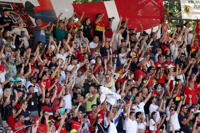 The Ferrari fans celebrate in the stands