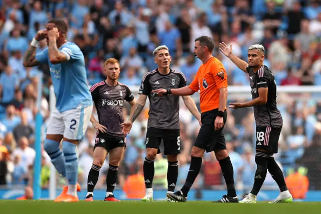 Harry Wilson and Andreas Pereira of Fulham react to Match Referee Michael Oliver