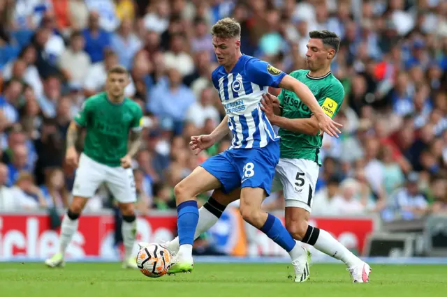 Ferguson holds up the ball under pressure from Schar.