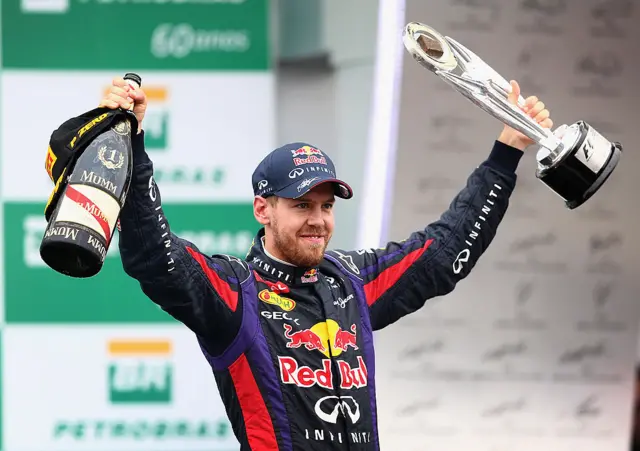 Sebastian Vettel celebrates winning in Brazil in 2013