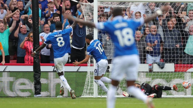 Everton players run to celebrate with goal scorer Arnaut Danjuma