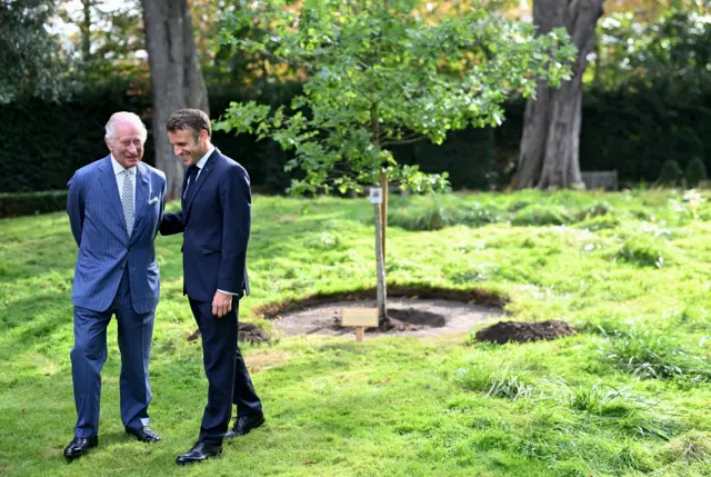 King Charles and Macron plant a tree in the garden of the residence to commemorate the state visit