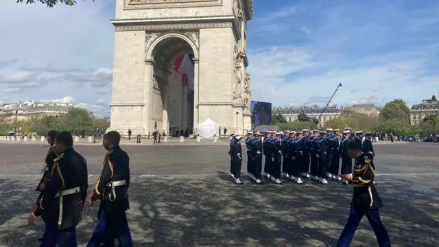 Members of the French military stand guard at the Arc de Triomphe