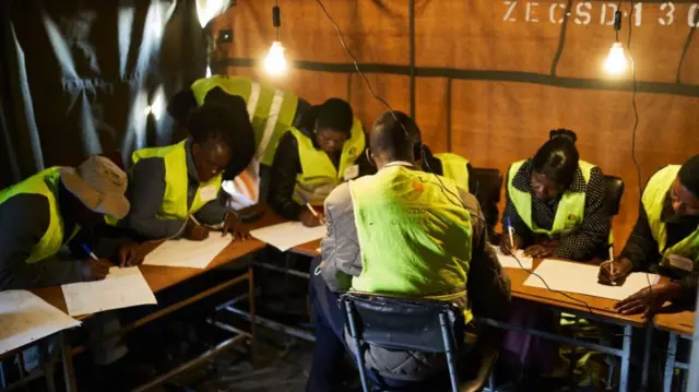 Zimbabwe Electoral Commission (ZEC) officials prepare for voting to begin at a polling station during Zimbabwe's presidential and legislative elections in Bulawayo on August 23, 2023. Zimbabweans on August 23, 2023 began voting in closely-watched presidential and legislative elections.