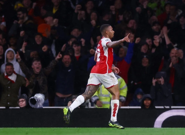 Gabriel Jesus runs towards fans to celebrate after scoring