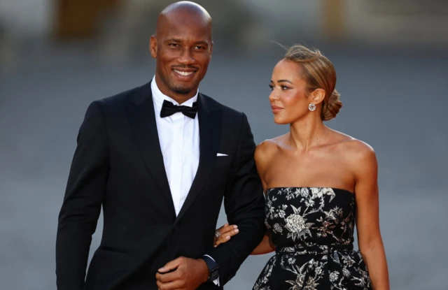 Didier Drogba and Gabrielle Lemaire arrive to attend a state dinner in honour of Britain's King Charles and Queen Camilla at the Chateau de Versailles