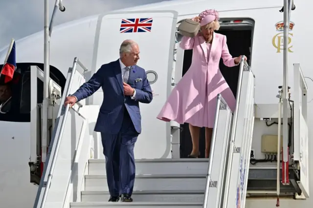 King and Queen step off plane