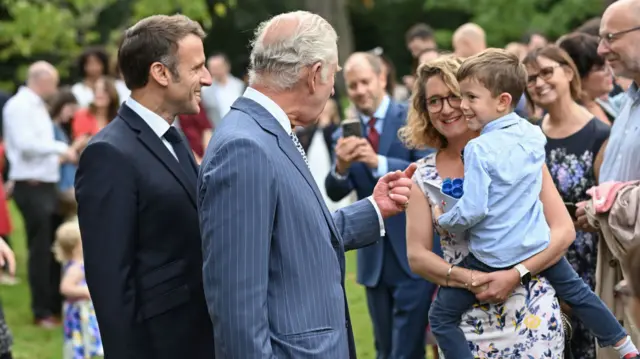 King Charles greets people in the Ambassasor's Residence in Paris after planting a tree