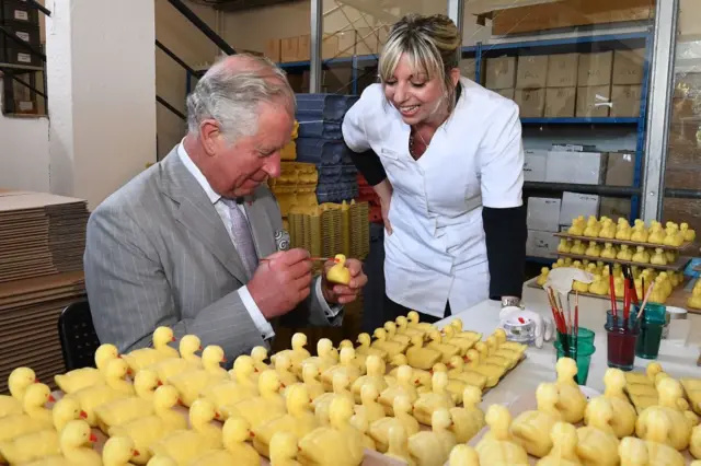 Charles paints perfumed duck shaped soap during a visit to the Parfumerie Fragonard laboratory plant near Nice, May 2018