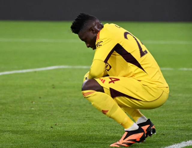 Andre Onana with his head down